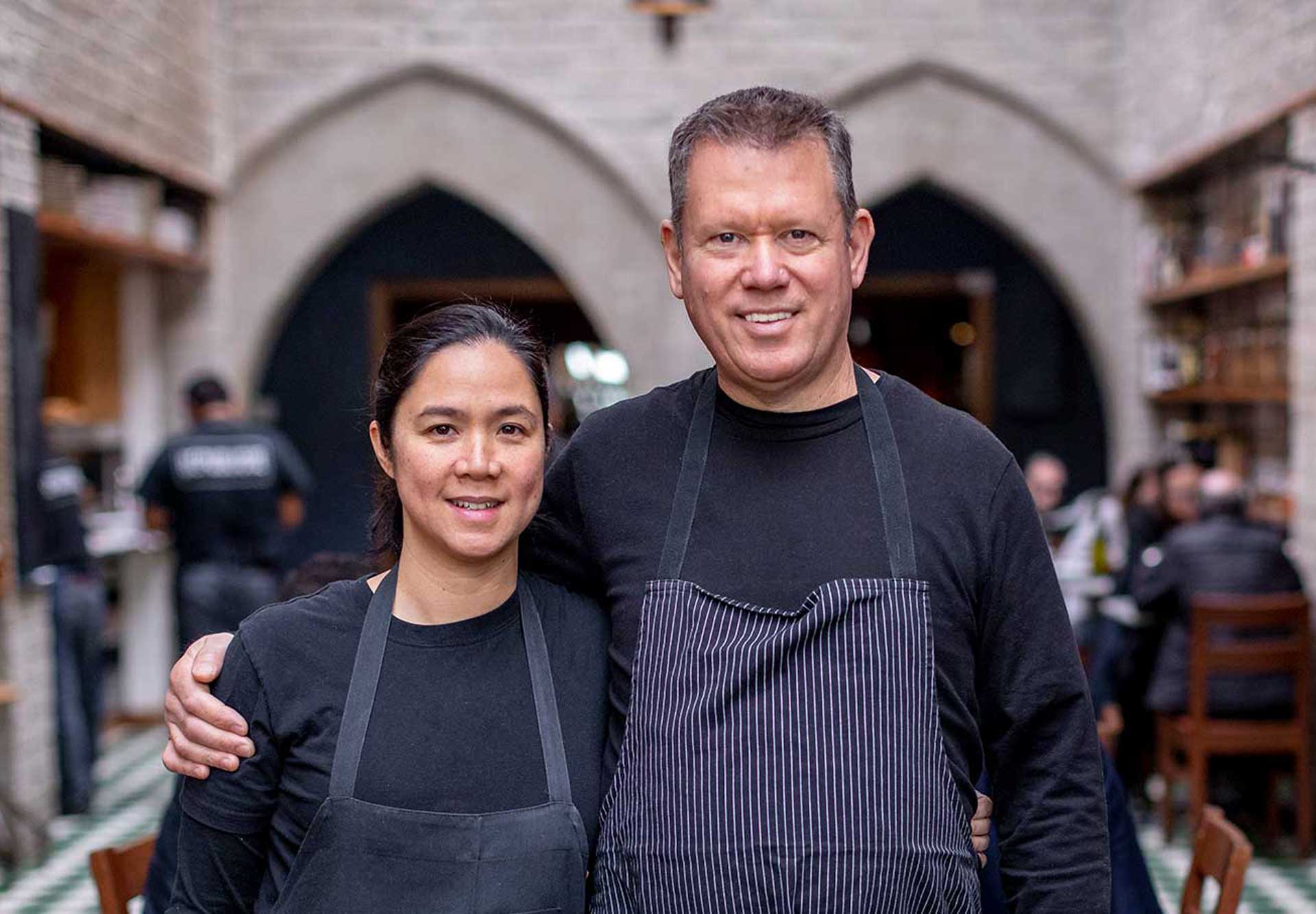 chef walter manzke and chef margarita manzke standing in the middle of the dining room at their restaurant republique